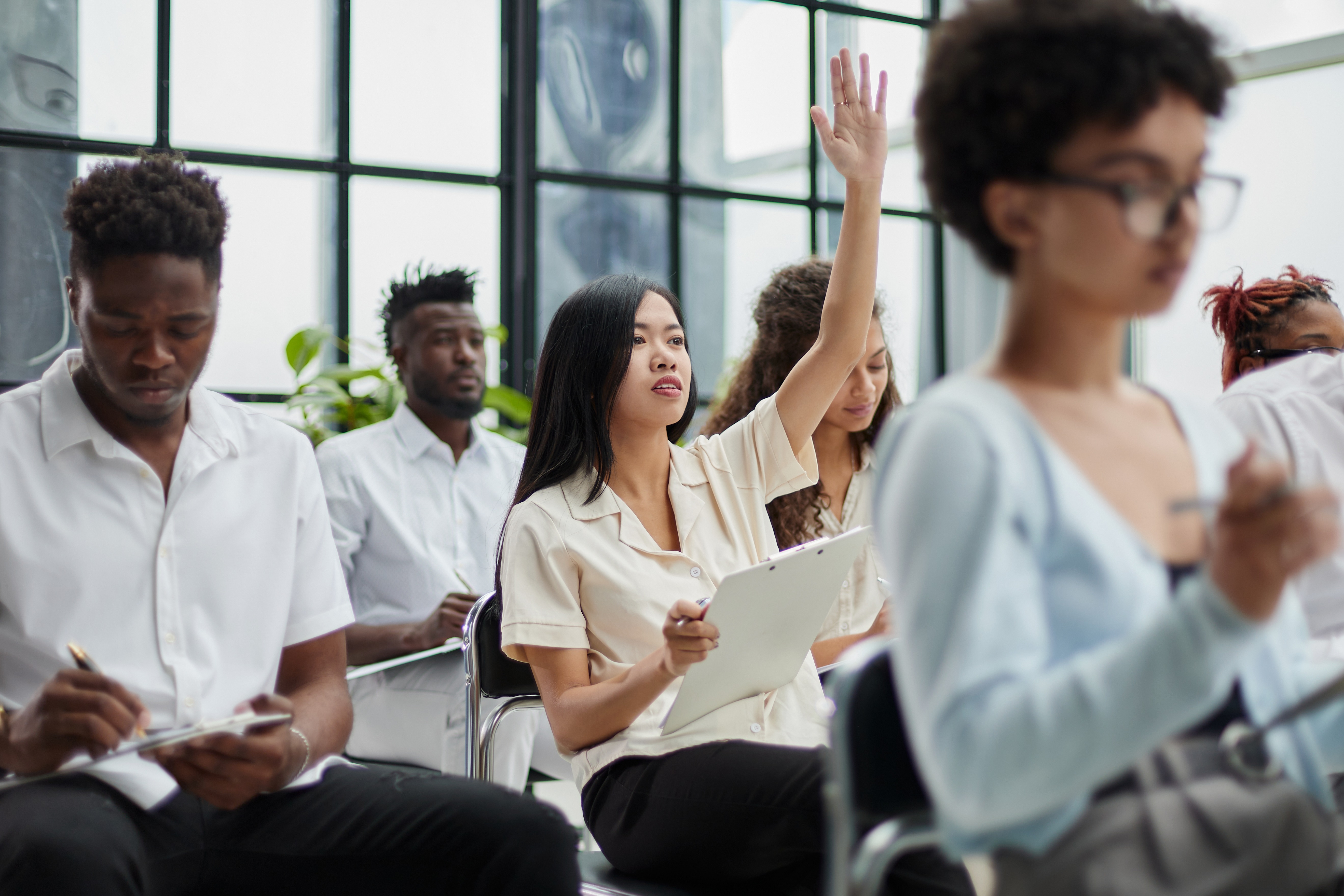 Image of a woman raising her hand 